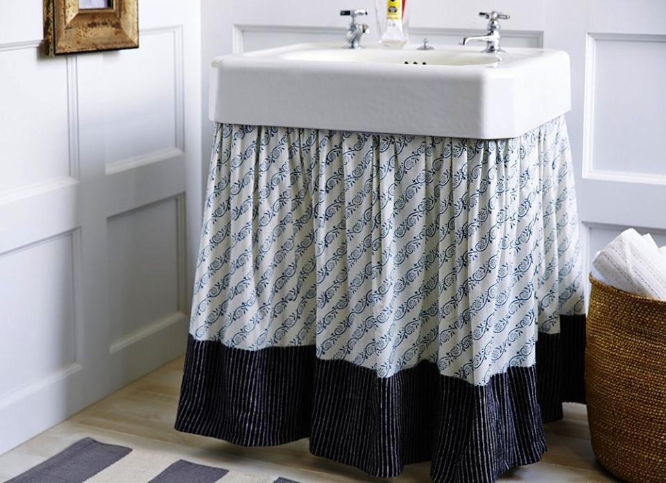 <body> <p>Pedestal sinks leave ample room underneath for space-smart wicker baskets or towel racks, but they do little to guard stored items from prying eyes. By adorning the rim of the sink with <a rel="nofollow noopener" href=" http://www.bobvila.com/slideshow/12-ways-to-hack-your-life-using-velcro-48802?bv=yahoo" target="_blank" data-ylk="slk:Velcro;elm:context_link;itc:0;sec:content-canvas" class="link ">Velcro</a>, and then adhering a stylish skirt, you can cloak clutter in secrecy and style!</p> <p><strong>Related: <a rel="nofollow noopener" href=" http://www.bobvila.com/slideshow/how-to-get-your-bathroom-guest-ready-in-20-minutes-or-less-49597#.VrvZmmTysy4?bv=yahoo" target="_blank" data-ylk="slk:How To—Get Your Bathroom Guest-Ready in 20 Minutes or Less;elm:context_link;itc:0;sec:content-canvas" class="link ">How To—Get Your Bathroom Guest-Ready in 20 Minutes or Less</a> </strong> </p> </body>