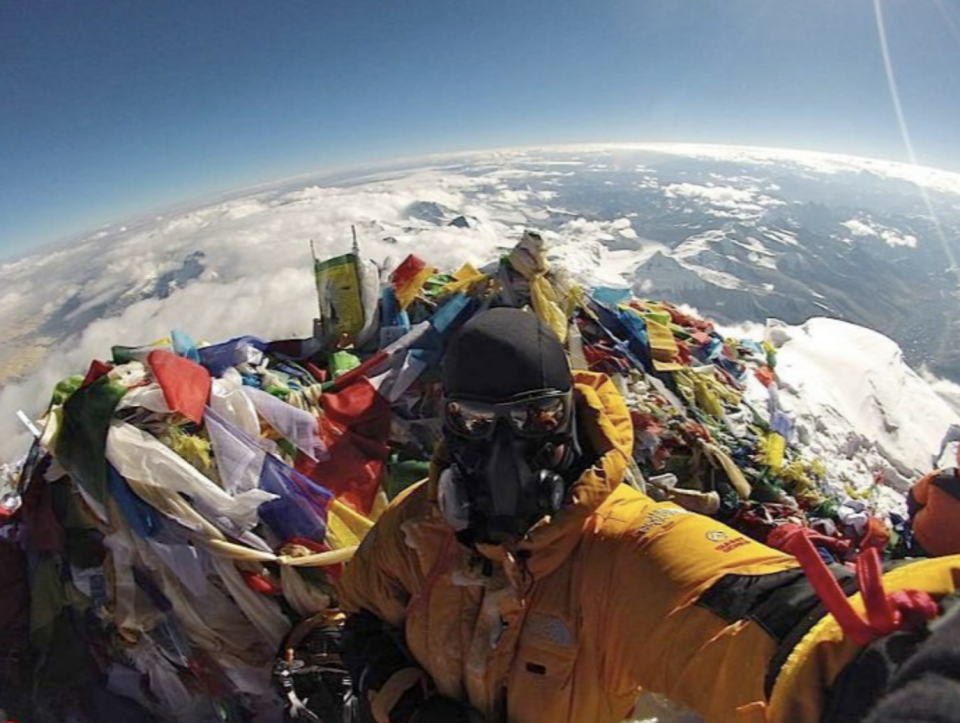 person taking a selfie at the top and it looks like he's at the top of the world