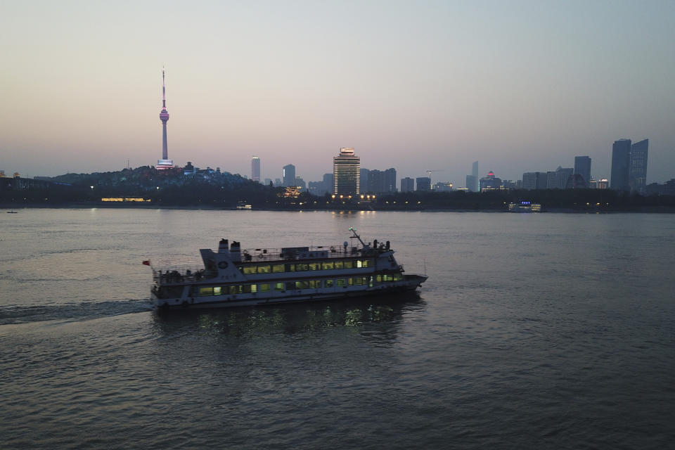 In this April 12, 2020 photo, a passenger ferry crosses the Yangtze River in Wuhan in central China's Hubei province. Wuhan has been eclipsed by Shanghai, Hong Kong and other coastal cities since the ruling Communist Party set off a trade boom by launching market-style economic reforms in 1979. But for centuries before that, the city was one of the most important centers of an inland network of river trade that dominated China's economy and politics. (AP Photo/Sam McNeil)