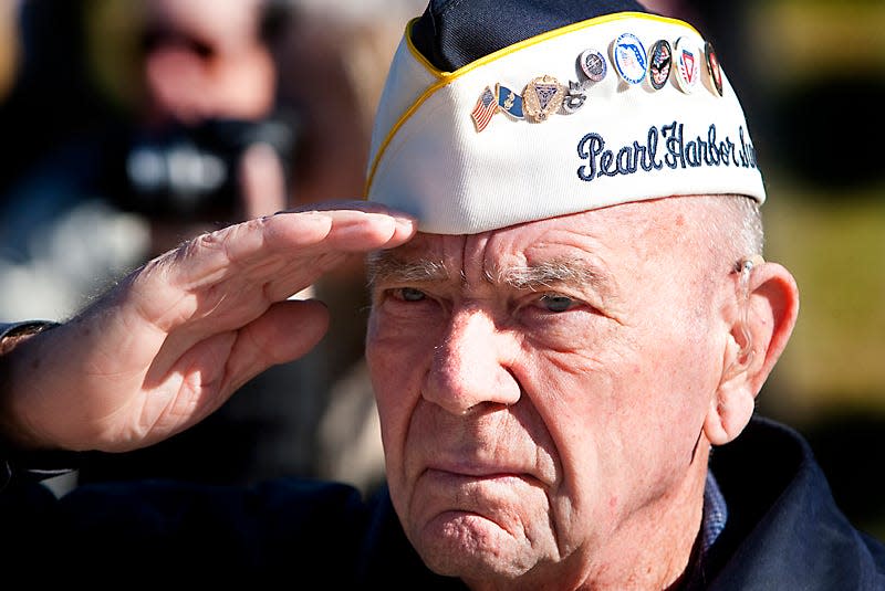 Pearl Harbor survivor Jack Edge salutes the American flag during the Presentation of Colors during the Pearl Harbor Remembrance Program at the Ocala/Marion County Veterans Memorial Park on Dec. 7, 2010, in Ocala. Edge was a seaman aboard the U.S.S. Pelias AS-14, which was a sub tender. Dec. 7, 2010 marked the 69th anniversary of the bombing of Pearl Harbor. Veterans and family members attended the event, which featured live patriotic music from the Kingdom of the Sun Concert Band and guest speakers.