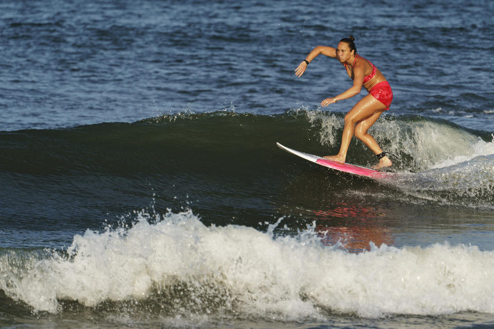 Carissa Moore rides a wave during a practice session at Tsurigasaki beach. - Credit: David Goldman/AP