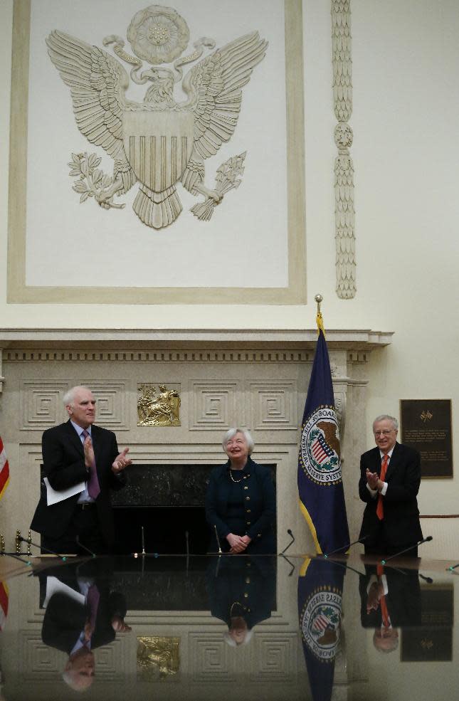 Janet Yellen is applauded after she was administered the oath of office as Federal Reserve Board chair by Fed Board Governor Daniel K. Tarullo, left, Monday, Feb. 3, 2014, at the Federal Reserve in Washington. Yellen's husband Nobel Prize winning economist George Akerlof is at right. Yellen is the first woman to lead the Federal Reserve. (AP Photo/Charles Dharapak)