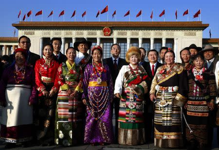 Qiangba Puncog (C), chairman of China's Tibet Autonomous Region, poses for an official photograph with members of the Tibetan provincial delegation as they arrive at the Great Hall of the People, for the start of the National People's Congress (NPC) in Beijing November 8, 2012. Picture taken November 8, 2012. REUTERS/David Gray