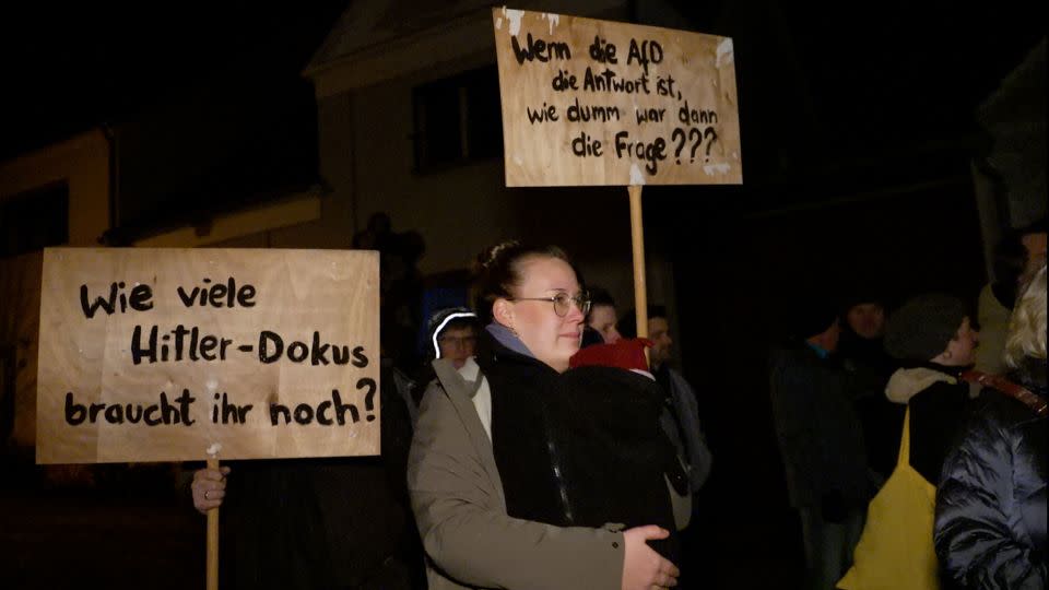 Protesters against the AfD demonstrate down the road from the meeting. The signs say: 'How many more Hitler documentaries do you need?' And: 'If the AfD is the answer, then how stupid was the question?' - Chris Stern/CNN