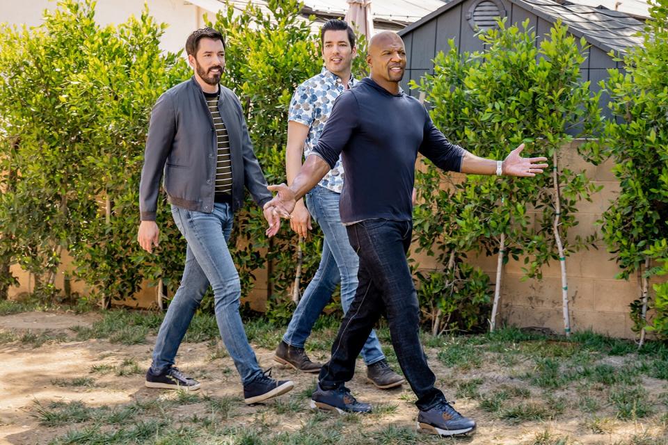 Terry Crews, along with Drew and Jonathan Scott, demo the outdoor living space for Terry&#39;s personal driver Frank, as seen on Celebrity IOU.