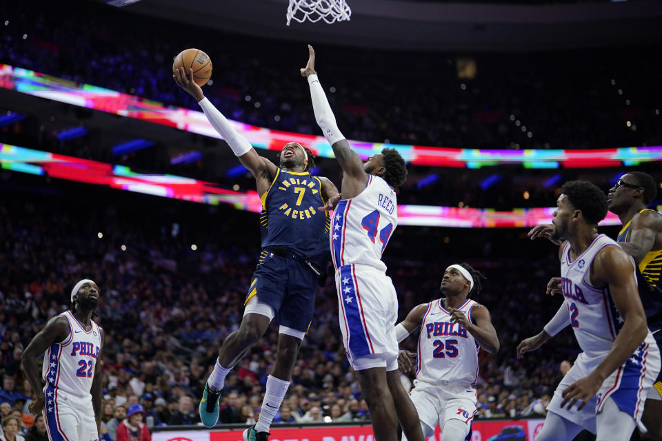 Indiana Pacers' Buddy Hield (7) goes up for a shot against Philadelphia 76ers' Paul Reed (44) during the second half of an NBA basketball game, Sunday, Nov. 12, 2023, in Philadelphia. (AP Photo/Matt Slocum)