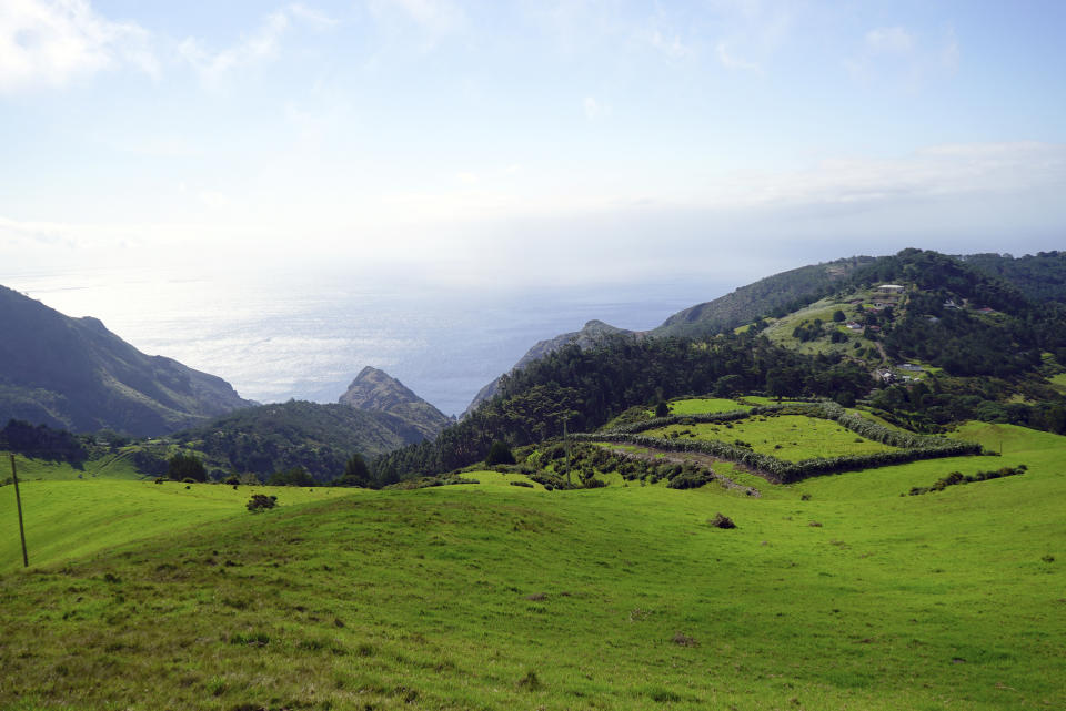 Scenic ocean views and rolling pastureland are seen on the island of St. Helena, Saturday, Feb. 24, 2024. The remote British overseas territory is home to diverse landscapes and microclimates, ranging from misty tropical forests to windswept volcanic cliffs. (AP Photo/Nicole Evatt)