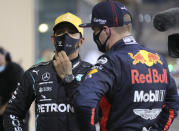 Red Bull driver Max Verstappen of the Netherlands, rught, talks to Mercedes driver Lewis Hamilton of Britain after the qualifying session at the Formula One Abu Dhabi Grand Prix in Abu Dhabi, United Arab Emirates, Saturday, Dec. 11, 2020. (AP Photo/Kamran Jebreili, Pool)