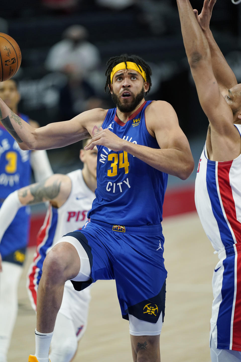 Denver Nuggets center JaVale McGee (34) makes a layup as Detroit Pistons center Jahlil Okafor defends during the first half of an NBA basketball game, Friday, May 14, 2021, in Detroit. (AP Photo/Carlos Osorio)