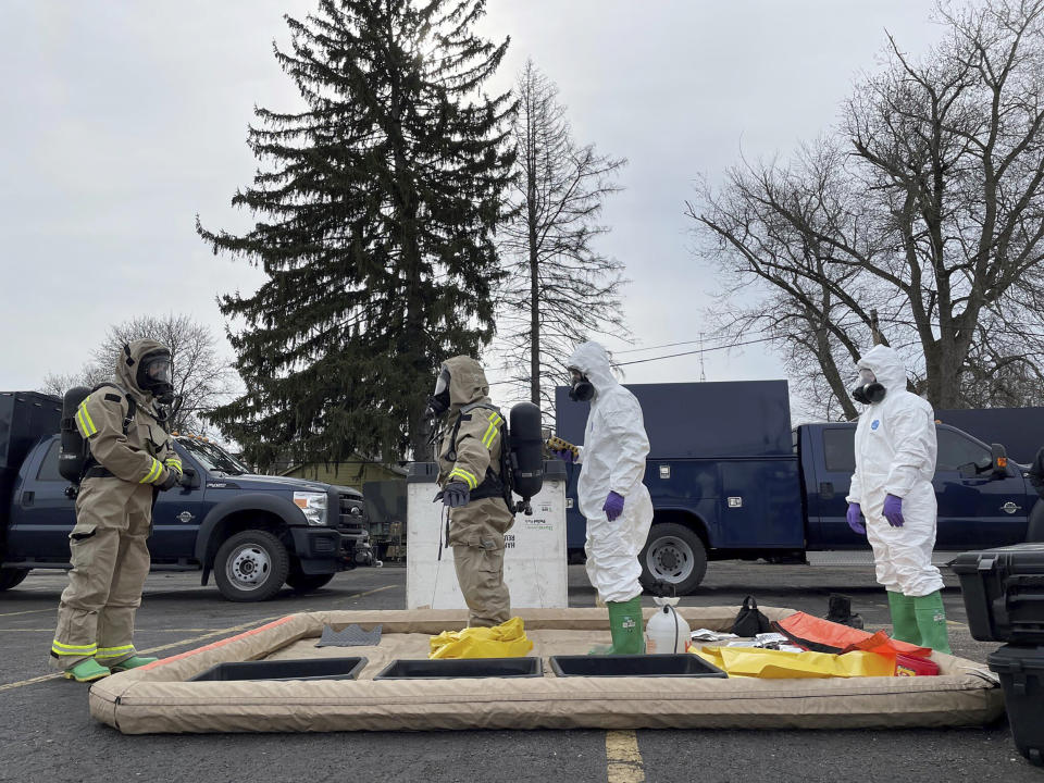 This photo provided by the Ohio National Guard, ONG 52nd Civil Support Team members prepare to enter an incident area to assess remaining hazards with a lightweight inflatable decontamination system (LIDS) in East Palestine, Ohio, Tuesday, Feb. 7, 2023. Authorities say air monitoring hasn’t detected dangerous levels of fumes in communities where crews released and burned toxic chemicals from a derailed train. But they said Tuesday that Ohio and Pennsylvania residents living close to the wreckage still aren’t being allowed in their homes.(Ohio National Guard via AP)