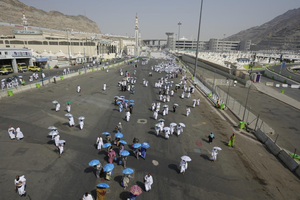 Muslim pilgrims arrive at the Mina tent camp during the annual Hajj pilgrimage, near the holy city of Mecca, Saudi Arabia, Friday, June 14, 2024. Hajj is the annual Islamic pilgrimage to Mecca in Saudi Arabia that is required once in a lifetime of every Muslim who can afford it and is physically able to make it. Some Muslims make the journey more than once. (AP Photo/Rafiq Maqbool)