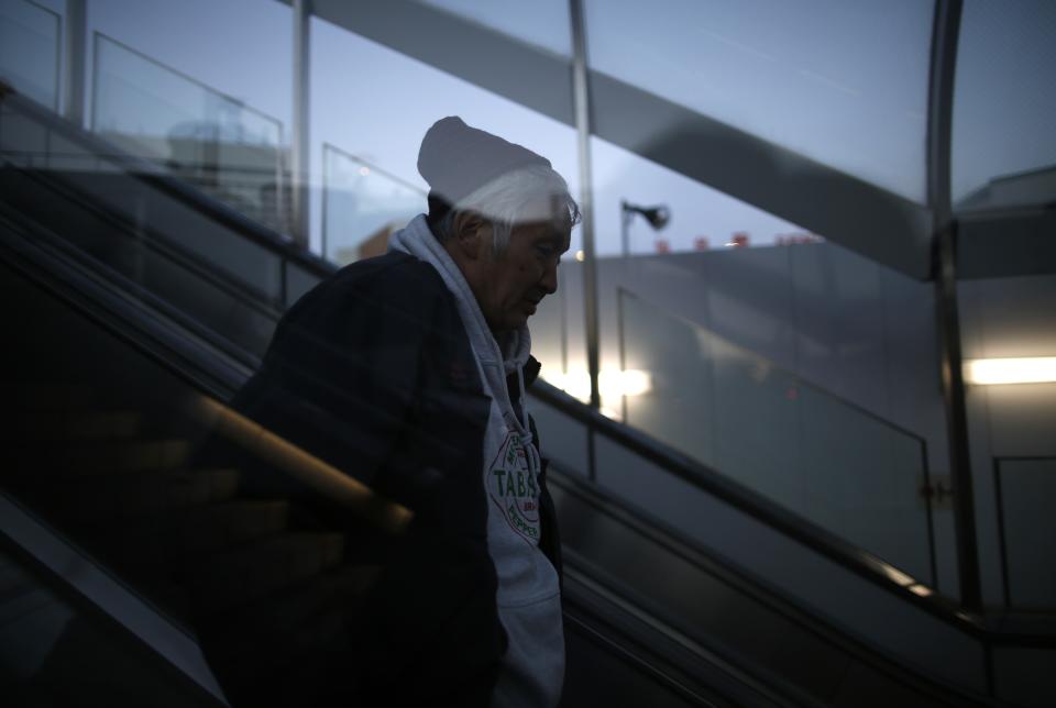 Shizuya Nishiyama (C), a 57-year-old homeless man from Hokkaido, walks at Sendai Station in Sendai, northern Japan December 18, 2013. (REUTERS/Issei Kato)