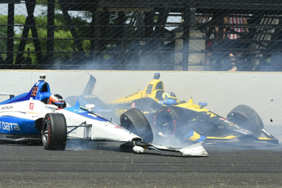 Felix Rosenqvist, of Sweden, left, and Zach Veach collide in the third turn during the Indianapolis 500 IndyCar auto race at Indianapolis Motor Speedway, Sunday, May 26, 2019, in Indianapolis. (AP Photo/Tom Pyle)