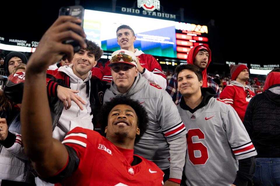 Ohio State safety Sonny Styles takes a photo with fans after last week's win over Minnesota.