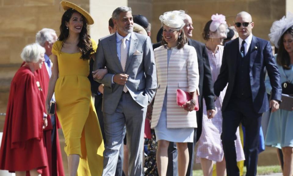 (L) Amal and George Clooney, and Tom Hardy (R) arrive at St George’s Chapel with other guests.