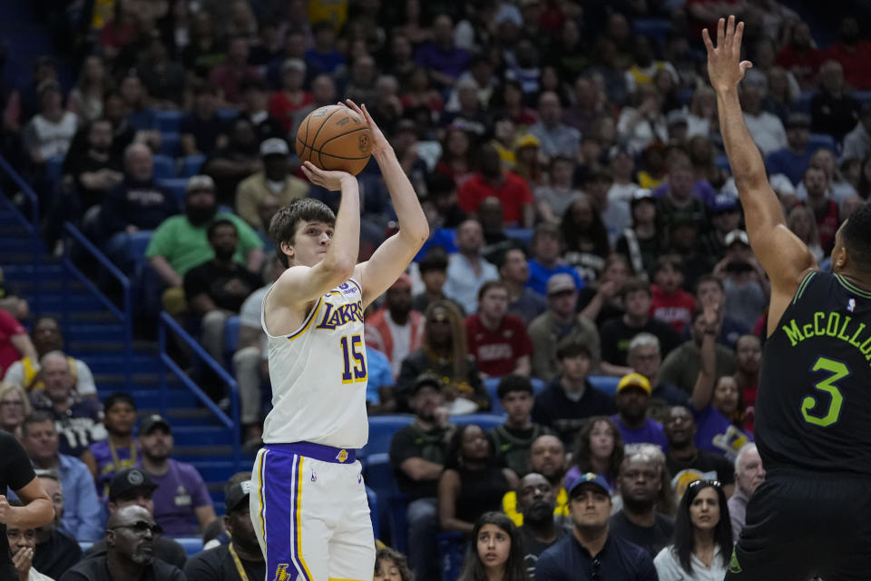 Los Angeles Lakers guard Austin Reaves (15) shoots a 3-point shot in the first half of an NBA basketball game against the New Orleans Pelicans in New Orleans, Sunday, April 14, 2024. (AP Photo/Gerald Herbert)