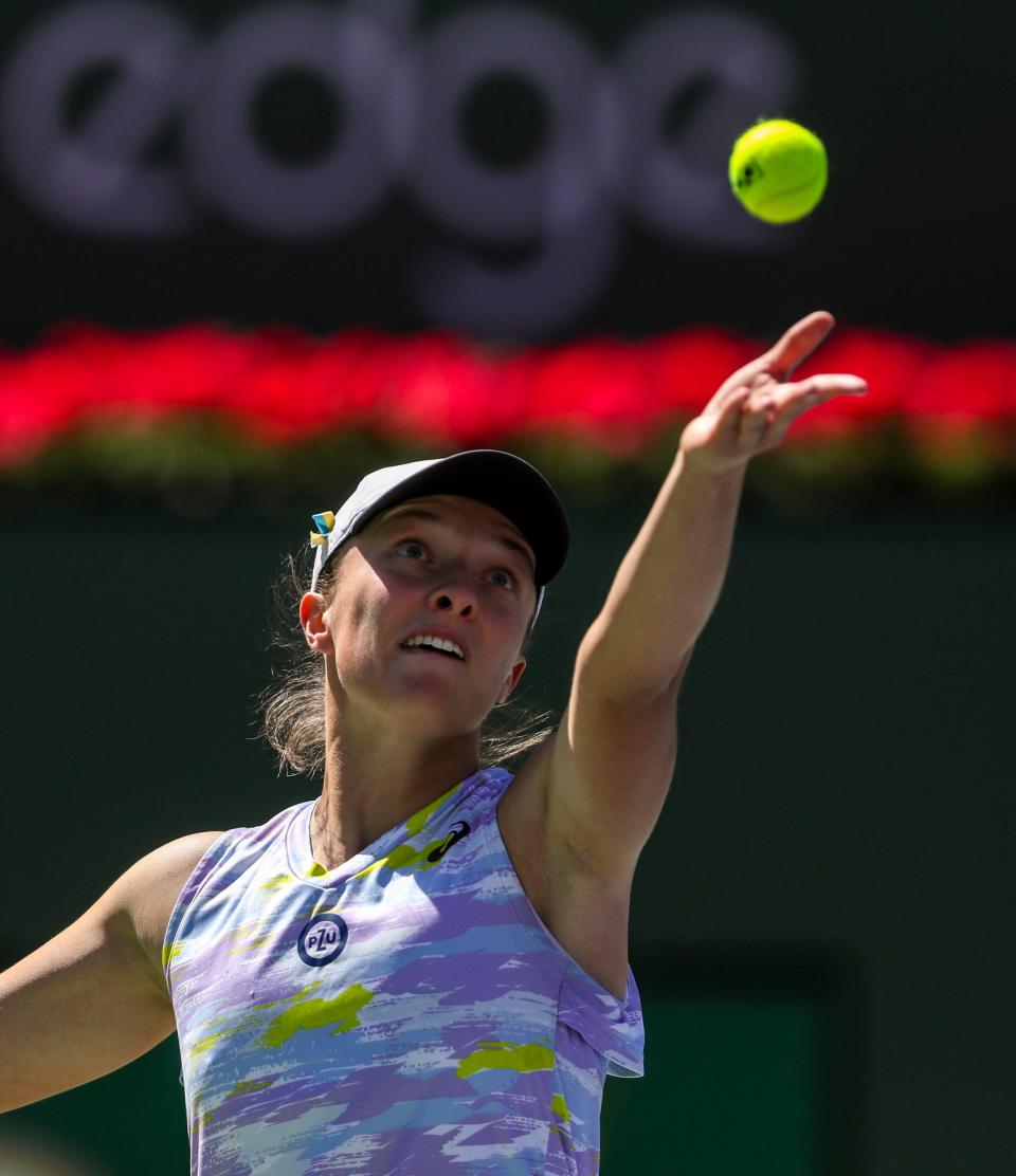 Iga Swiatek of Poland serves to Maria Sakkari of Greece during the WTA singles final at the BNP Paribas Open at the Indian Wells Tennis Garden in Indian Wells, Calif., Sunday, March 20, 2022. 