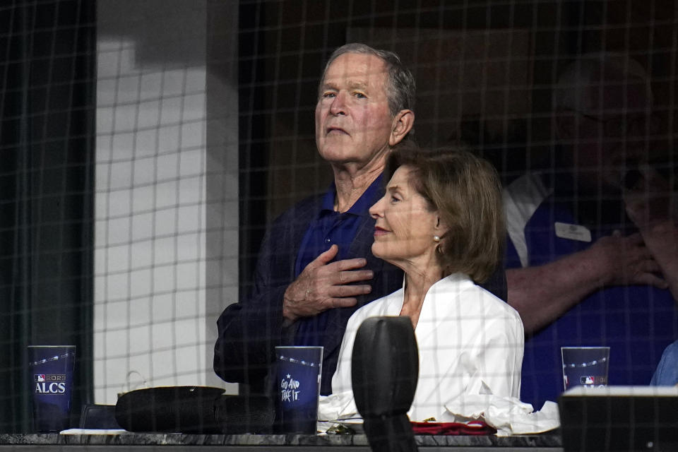 Former President George W. Bush and wife Laura watch before Game 3 of the baseball American League Championship Series between the Texas Rangers and Houston Astros Wednesday, Oct. 18, 2023, in Arlington, Texas. (AP Photo/Julio Cortez)