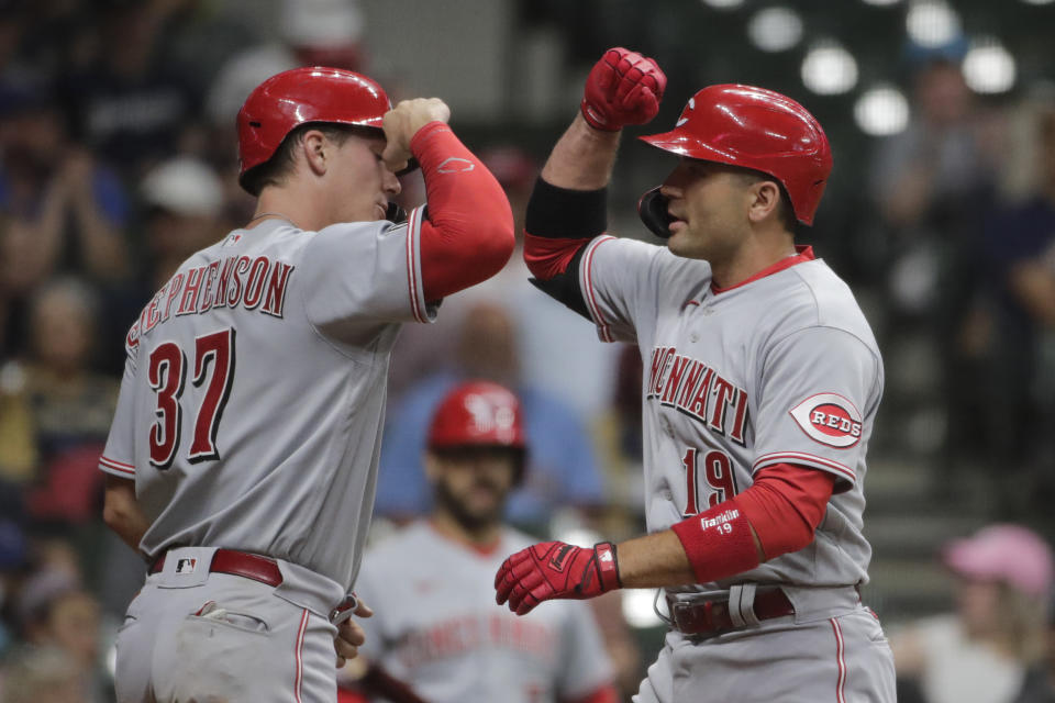 Cincinnati Reds' Joey Votto (19) is congratulated by Tyler Stephenson (37) after hitting a two-run home run during the seventh inning of a baseball game against the Milwaukee Brewers, Monday, June 14, 2021, in Milwaukee. (AP Photo/Aaron Gash)