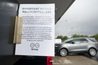 A sign indicating a limit on the amount of fuel sold out is seen at a petrol station in Manchester, Monday, Sept. 27, 2021. British Prime Minister Boris Johnson is said to be considering whether to call in the army to deliver fuel to petrol stations as pumps ran dry after days of panic buying. ( AP Photo/Jon Super)