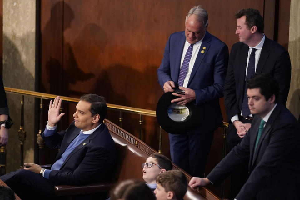 Rep.-elect George Santos, R-N.Y. waves in the chamber during opening day of the 118th Congress at the U.S. Capitol, Tuesday, Jan 3, 2023, in Washington. At top, second from right, is Rep.elect Ryan Zinke, R-Mont. (AP Photo/Andrew Harnik)