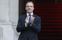 Britain's Foreign secretary Dominic Raab applauds at the Foreign Office in London during the weekly "Clap for our Carers" in London, Thursday, April 23, 2020. The COVID-19 coronavirus pandemic has prompted a public display of appreciation for care workers. The applause takes place across Britain every Thursday at 8pm local time to show appreciation for healthcare workers, emergency services, armed services, delivery drivers, shop workers, teachers, waste collectors, manufacturers, postal workers, cleaners, vets, engineers and all those helping people with coronavirus and keeping the country functioning while most people stay at home in the lockdown. (AP Photo/Frank Augstein/pool)