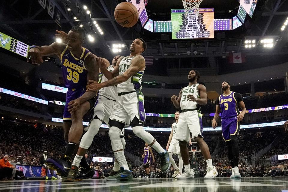 Los Angeles Lakers' Dwight Howard is fouled by Milwaukee Bucks' George Hill during the first half of an NBA basketball game Wednesday, Nov. 17, 2021, in Milwaukee. The Bucks won 109-102. (AP Photo/Morry Gash)