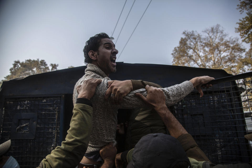 Indian police detain an activist of Peoples Democratic party (PDP) protesting against India's new land laws that allows any Indian citizen to buy land in the disputed region in Srinagar, Indian controlled Kashmir, Thursday, Oct. 29, 2020. Until last year, Indians were not allowed to buy property in the region. But in August 2019, Prime Minister Narendra Modi’s government scrapped the disputed region’s special status, annulled its separate constitution, split the region into two federal territories. (AP Photo/Mukhtar Khan)