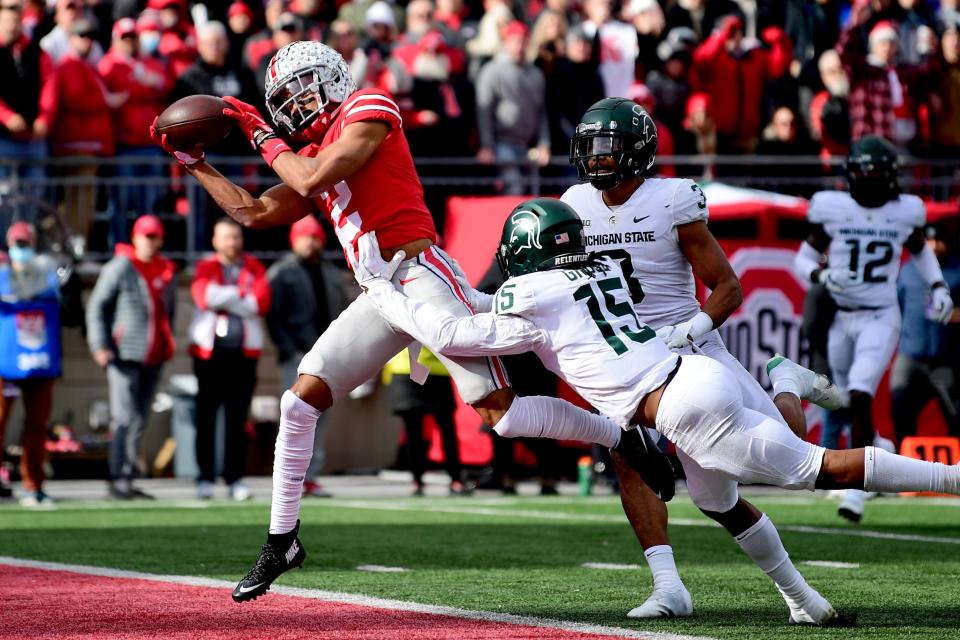 Chris Olave of the Ohio State Buckeyes catches a pass for a touchdown during the first half of a game against the Michigan State Spartans at Ohio Stadium on Nov. 20, 2021 in Columbus, Ohio.