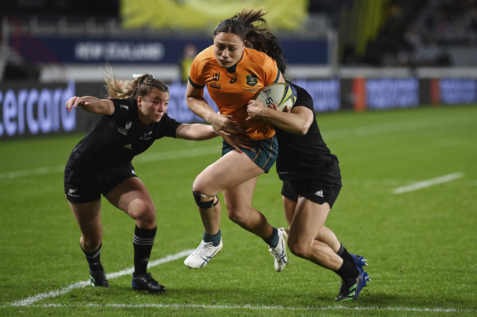 Bienne Terita of Australia runs at the defense during the Women's Rugby World Cup pool match between Australia and New Zealand, at Eden Park, Auckland, New Zealand, Saturday, Oct.8. 2022. (Andrew Cornaga/Photosport via AP)