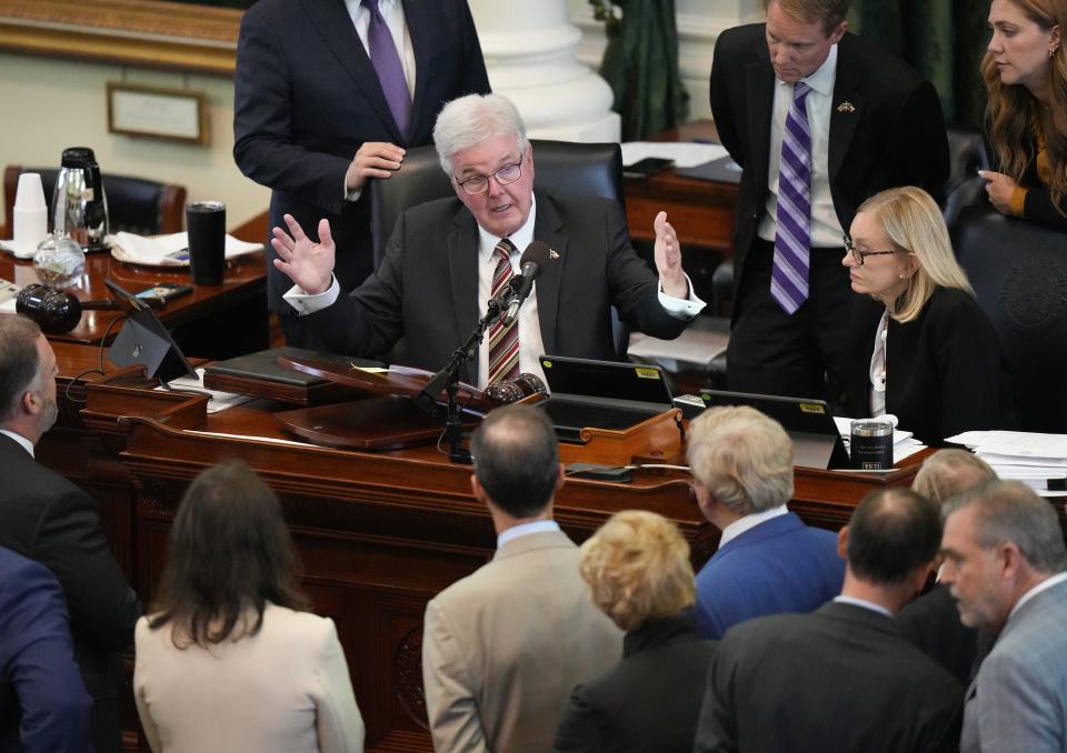 Lt. Gov. Dan Patrick talks to lawyers after the defense rested at the impeachment trial of Attorney General Ken Paxton in the Texas Senate on Sept. 14.