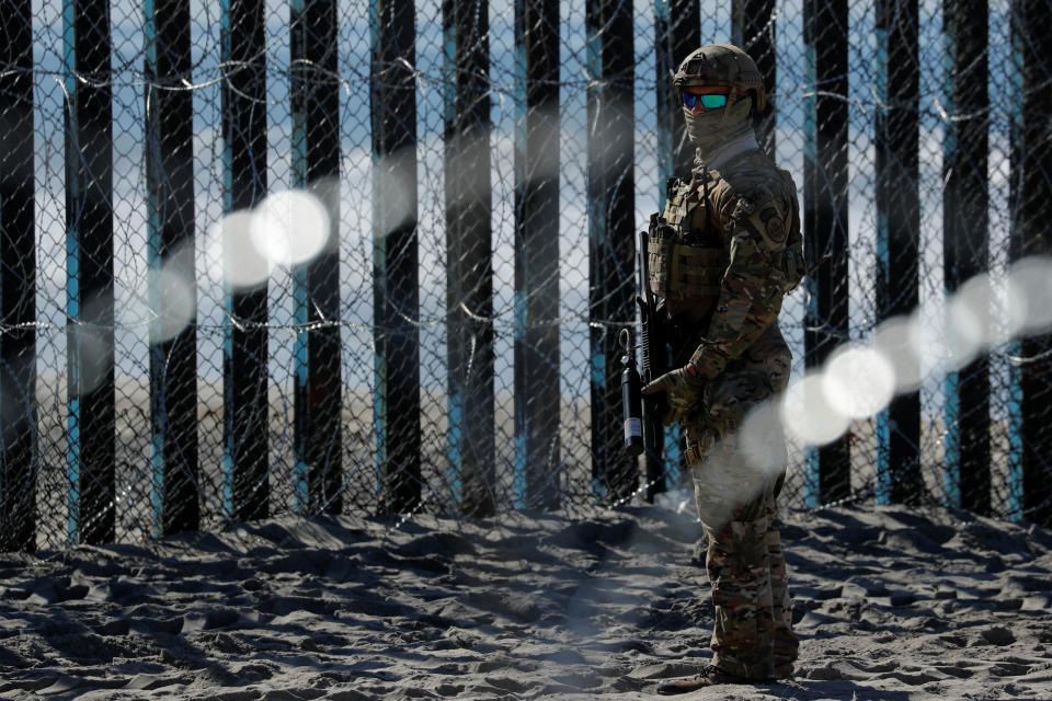 An armed U.S. Customs and Border Patrol agent stands guard at the border fence next to the beach in Tijuana, at the Border State Park in San Diego in November. (Photo: Mike Blake/Reuters)