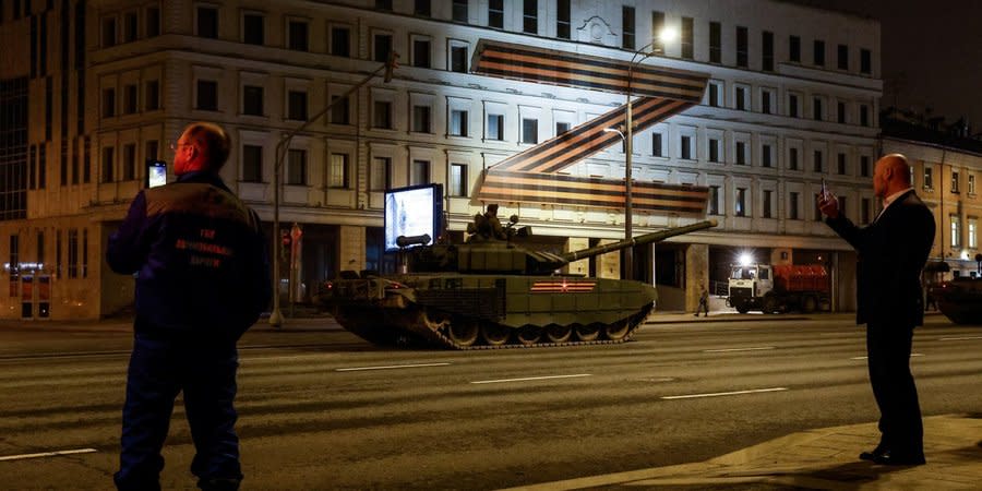 On the streets of Moscow, people take pictures of Russian military equipment being moved to the city to take part in the May 9 parade, April 21, 2022