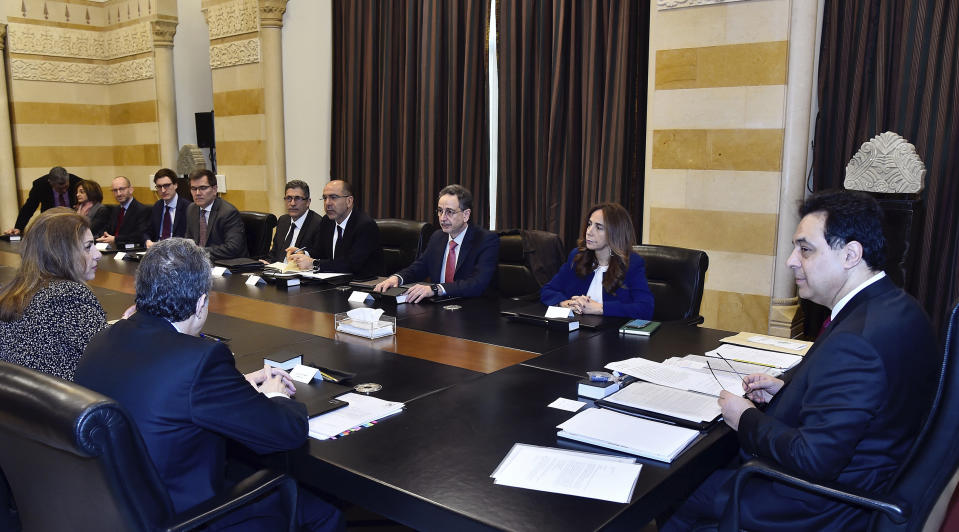 In this photo released by the Lebanese Government, Lebanese Prime Minister Hassan Diab, right, meets with delegation from the International Monetary Fund at the Government House in Beirut, Lebanon, Thursday, Feb. 20, 2020. A delegation from the International Monetary Fund began its meetings in Lebanon Thursday where the international agency is expected to give an assessment on what is needed to save the crumbling economy of the country. (Dalati Nohra/Lebanese Government via AP)