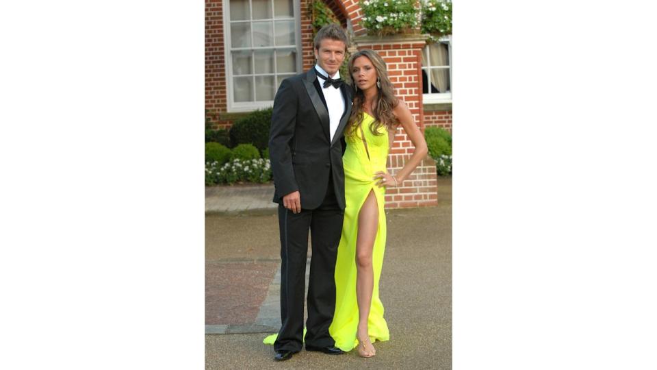 David Beckham in a suit and Victoria in a yellow dress