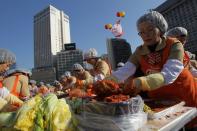 SEOUL, SOUTH KOREA - NOVEMBER 15: More than two thousands of housewives make Kimchi for donation to the poor in preparation for winter in front of City Hall on November 15, 2012 in Seoul, South Korea. Kimchi is a traditional Korean dish of fermented vegetables usually mixed with chili and eaten with rice or served as a side dish to a main meal. (Photo by Chung Sung-Jun/Getty Images)