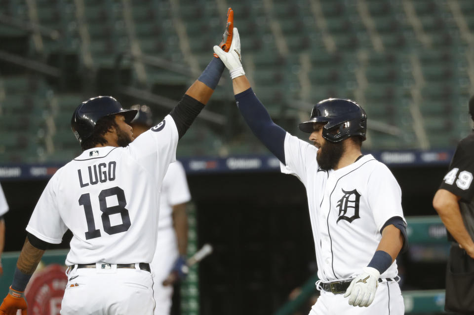 Detroit Tigers' Austin Romine, right, celebrates his two-run home run with Dawel Lugo (18) against the Chicago White Sox in the fifth inning of a baseball game in Detroit, Tuesday, Aug. 11, 2020. (AP Photo/Paul Sancya)