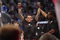 Dustin Poirier is declared the winner after Conor McGregor was injured during a UFC 264 lightweight mixed martial arts bout Saturday, July 10, 2021, in Las Vegas. (AP Photo/John Locher)