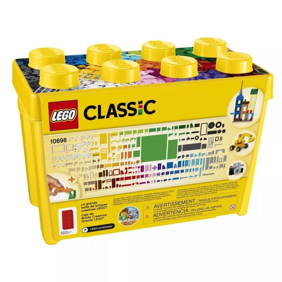 Yellow plastic bin of Legos with all the pieces included shown