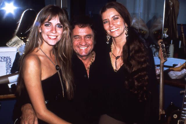 <p>Roberta Bayley/Redferns/Getty</p> Carlene Carter with stepfather Johnny Cash and mom June Carter Cash