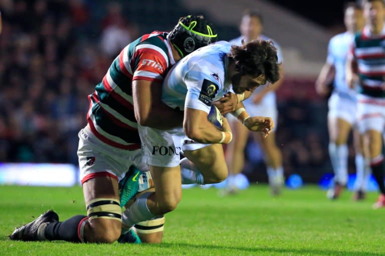 Racing 92's scrum-half Maxime Machenaud (R) is tackled during a European Champions Cup match against Leicester Tigers on October 23, 2016