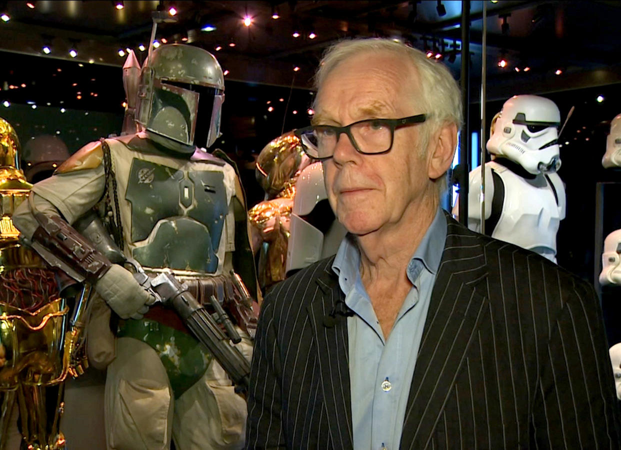 Jeremy Bulloch speaks in front of the costume he wore while playing Boba Fett in &quot;Star Wars: Episode V – The Empire Strikes Back&quot; and &quot;Star Wars: Episode VI – Return of the Jedi&quot; at the Star Wars Identities exhibition in London on July 26, 2017. Bulloch, the English actor who played Boba Fett in the original &quot;Star Wars&quot; trilogy, has died. His agents said in a statement that he died in a London hospital Thursday, Dec. 17, 2020, after years of suffering from Parkinson&#39;s disease. He was 75. (AP Photo)