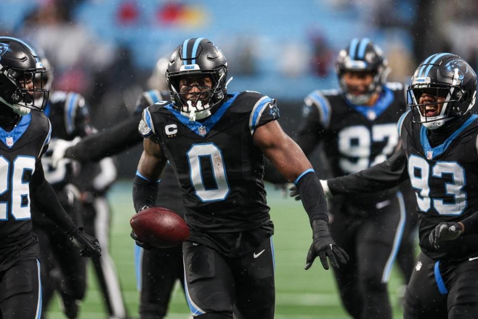 Panthers outside linebacker Brian Burns (0) runs the ball to the end zone in celebration after a fumble recovery against the Falcons during the game at Bank of America Stadium on Sunday, December 16, 2023.