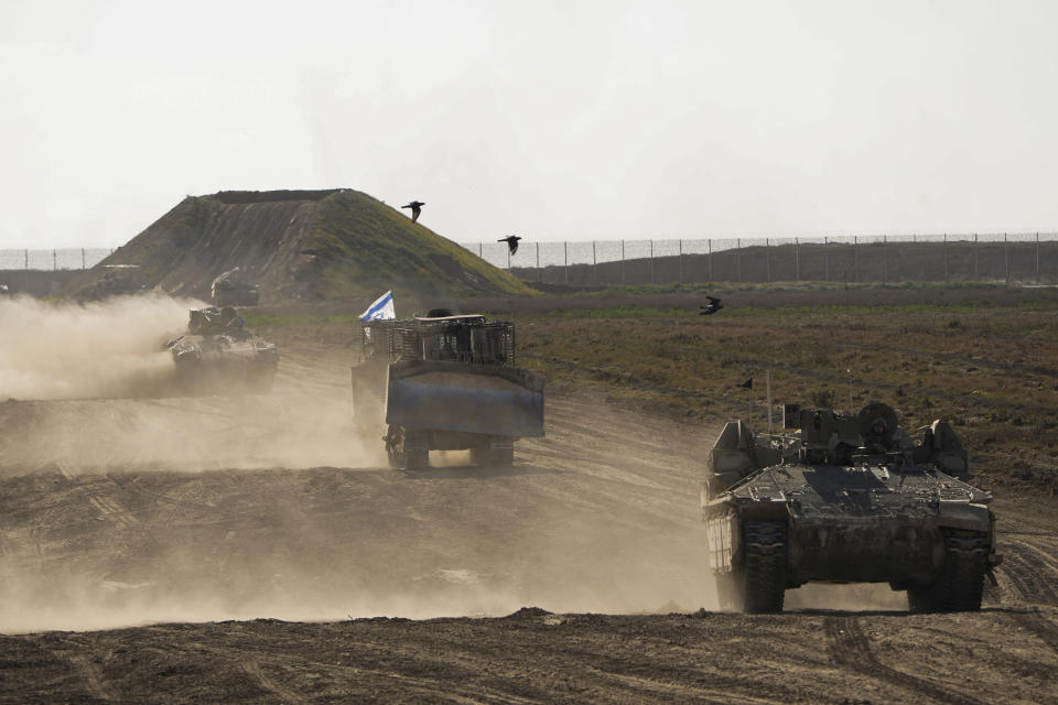Israeli troops move near the Gaza Strip border in southern Israel, Monday, March 4, 2024. The army is battling Palestinian militants across Gaza in the war ignited by Hamas' Oct. 7 attack into Israel. (AP Photo/Ohad Zwigenberg)