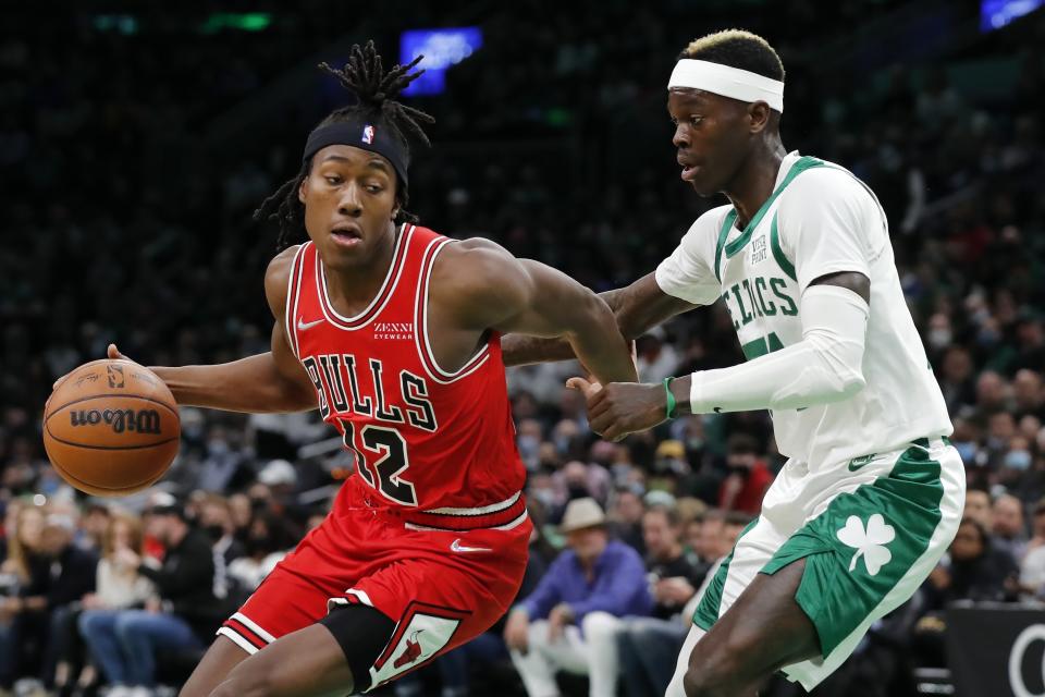 Chicago Bulls' Ayo Dosunmu (12) drives past Boston Celtics' Dennis Schroder during the first half of an NBA basketball game, Monday, Nov. 1, 2021, in Boston. (AP Photo/Michael Dwyer)