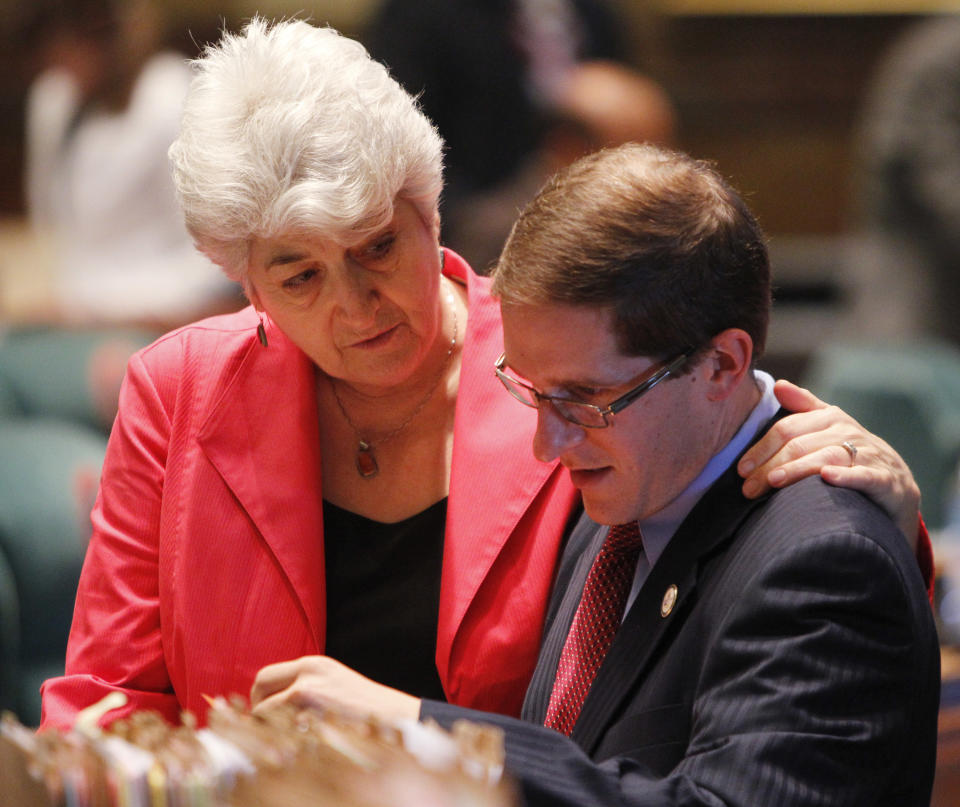 Rep. Lois Court, left, D-Denver, talks with House Minority Leader Mark Ferrandino, D-Denver, in the House chamber at the Capitol in Denver on Wednesday, May 9, 2012. Wednesday was the last day of the session. (AP Photo/Ed Andrieski)