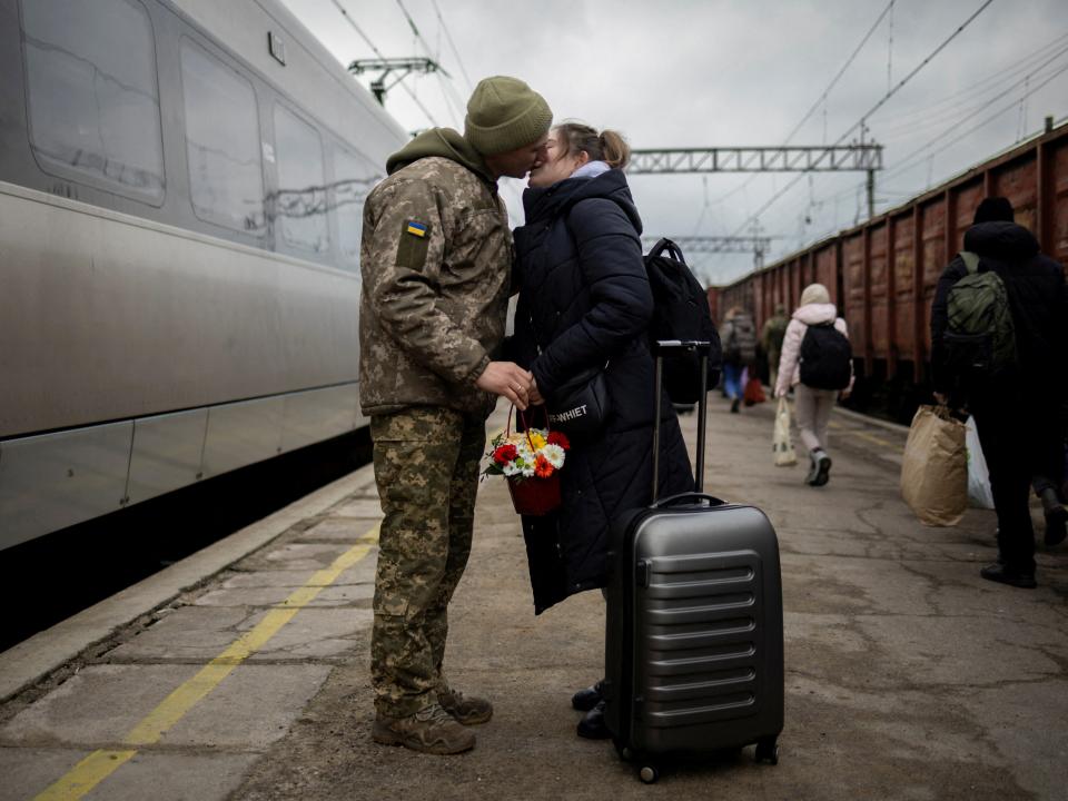 Ukrainian serviceman Vyacheslav greets his wife Viktoria who is visiting him during a short Christmas break from his frontline duty, at the station in Kramatorsk (REUTERS)