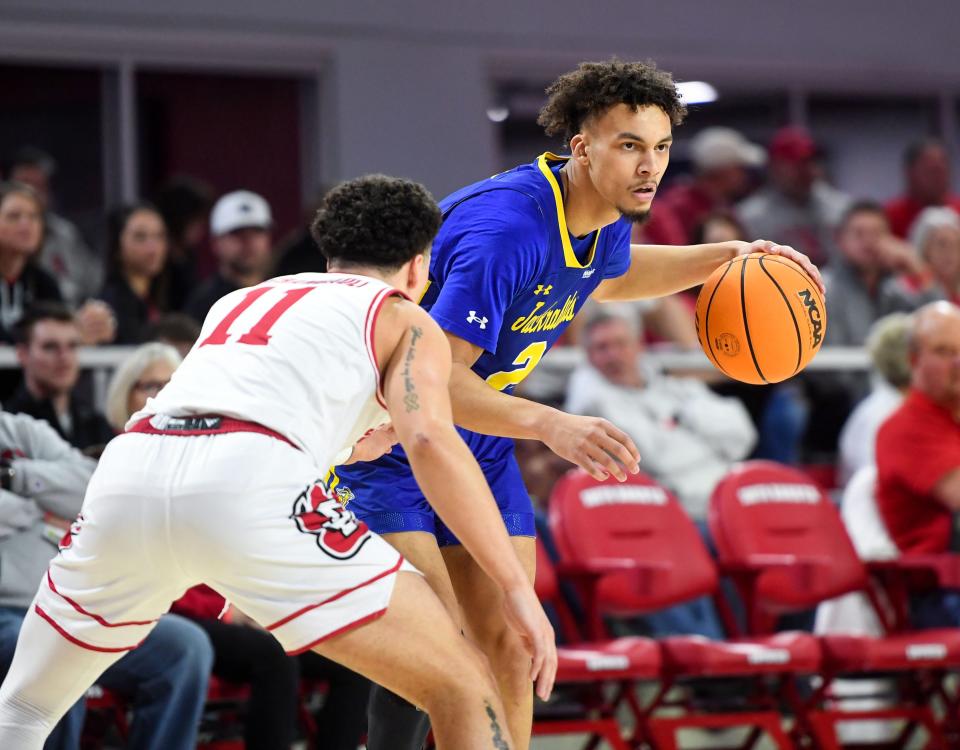 South Dakota State’s Zeke Mayo dribbles the ball, guarded by South Dakota’s Mason Archambault, in a rivalry matchup on Saturday, January 14, 2023, at the Sanford Coyote Sports Center in Vermillion.