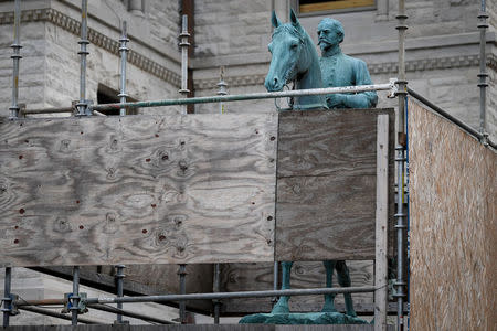 A monument to Confederate General John Hunt Morgan stands encased in a protective scaffolding because of local construction, outside the Old Courthouse in Lexington, Ky., U.S., August 15, 2017. REUTERS/Bryan Woolston