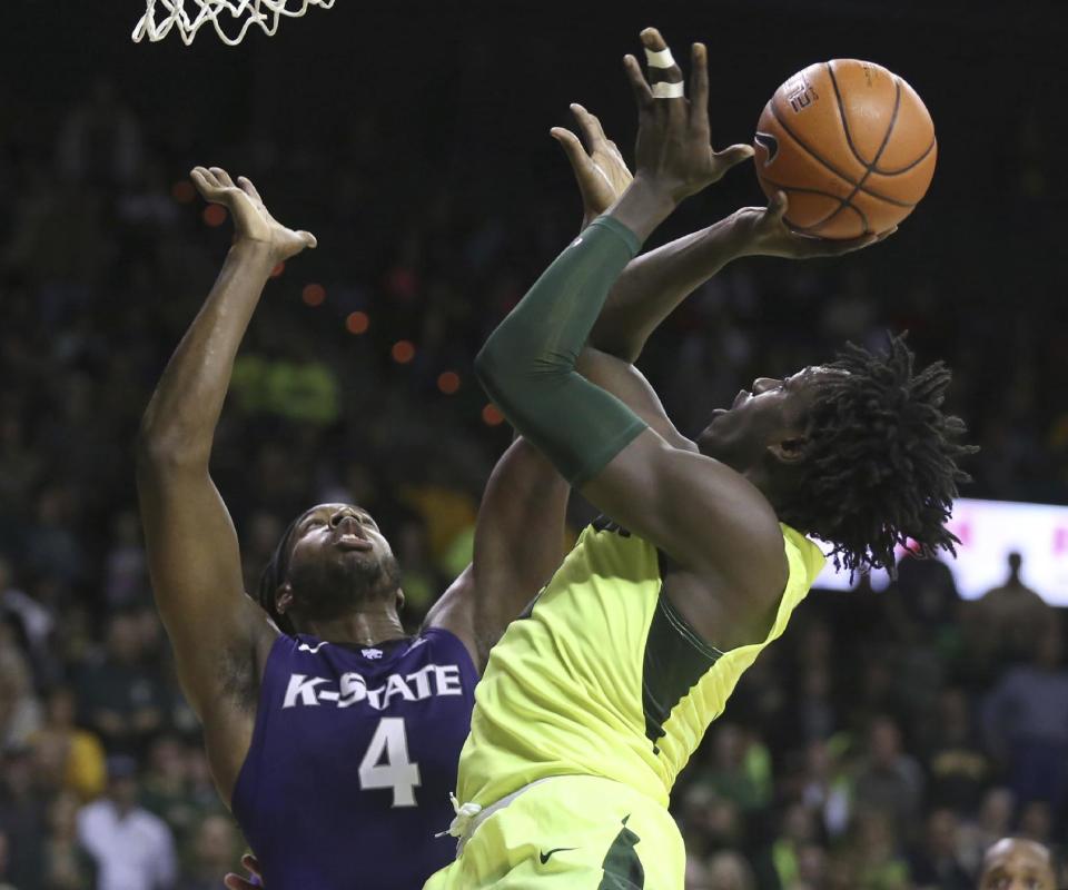 Baylor forward Johnathan Motley, right, shoots over Kansas State forward D.J. Johnson, left, in the second half of an NCAA college basketball game, Saturday, Feb. 4, 2017, in Waco, Texas. Kansas State won 56-54. (AP Photo/Rod Aydelotte)